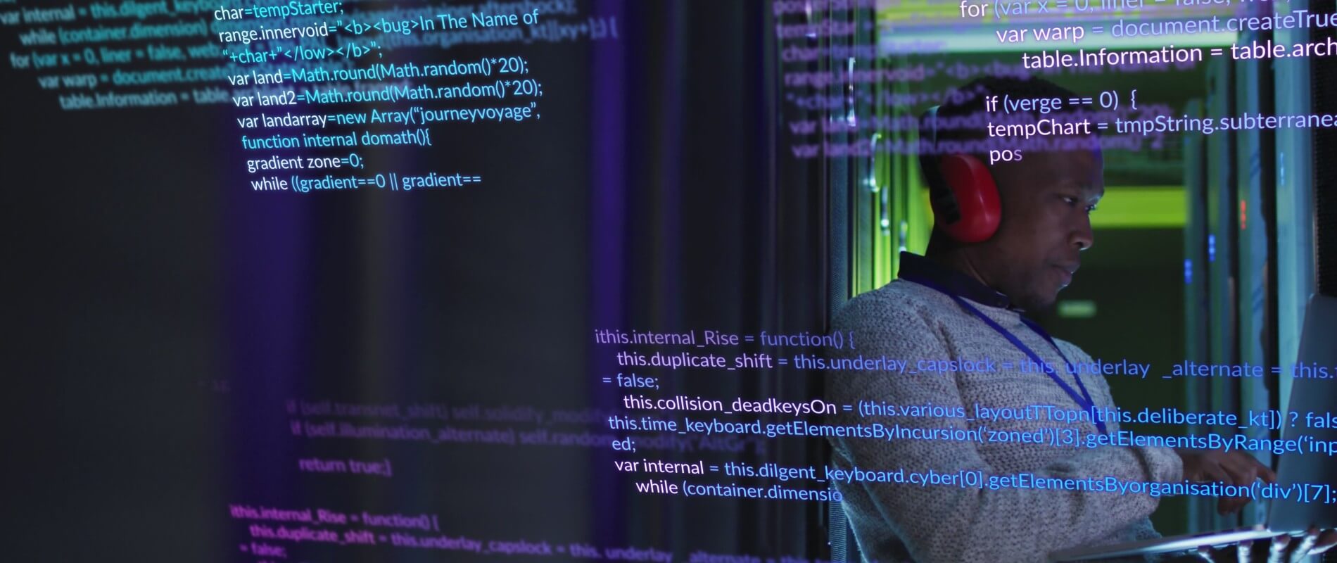 Developer working in a server room with lines of obfuscated code