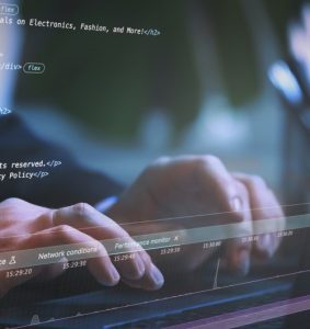Hands typing on a keyboard representing software development and license protection